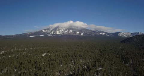 Aerial Timelapse of clouds boiling over snowy mountain range in northern Arizona Stock Footage 101858531