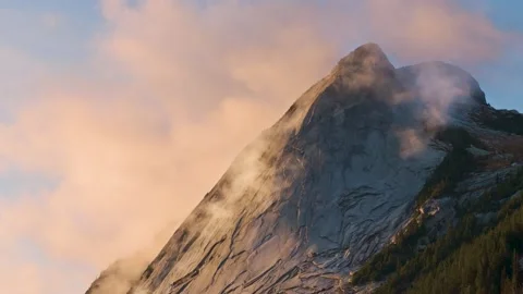 Aerial Timelapse of Colorful Sunset Clouds Swirling around a Granite Mountain Pe Stock Footage 273963385