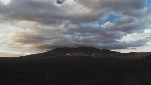 Aerial timelapse of dramatic clouds moving over mountains and pine forest Stock Footage 127269692