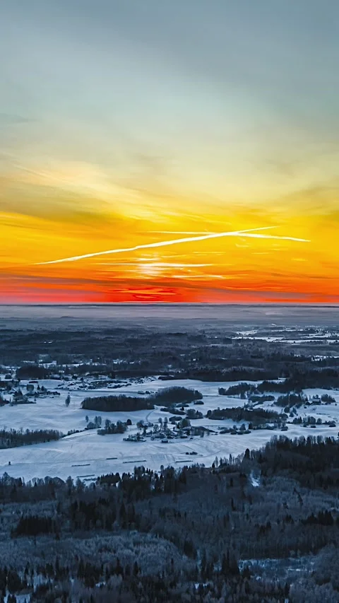 Aerial Timelapse of Snowy Winter Fields and Forests at Sunset with Vibrant Sky Stock Footage 337649417