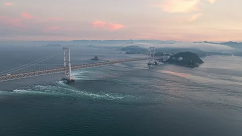 Aerial timelapse: Strong tidal current under Naruto Bridge at sunset Stock Footage 201092651