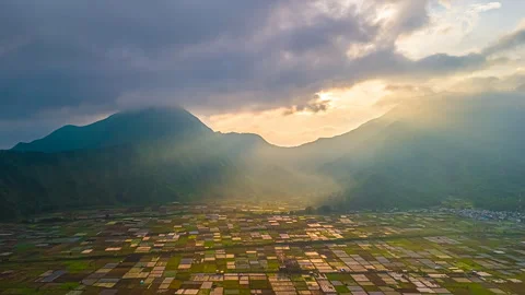 Aerial timelapse of sunrise over Bukit Selong farmland and mountains, Indonesia Stock Footage 307981453