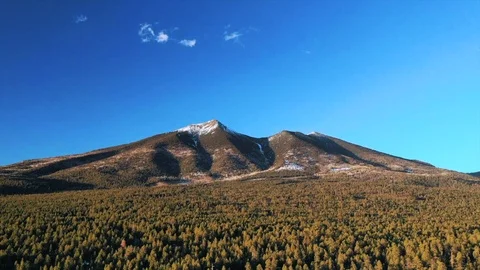 Aerial timelapse of tiny clouds over mountains and forest at sunset Stock Footage 127332920