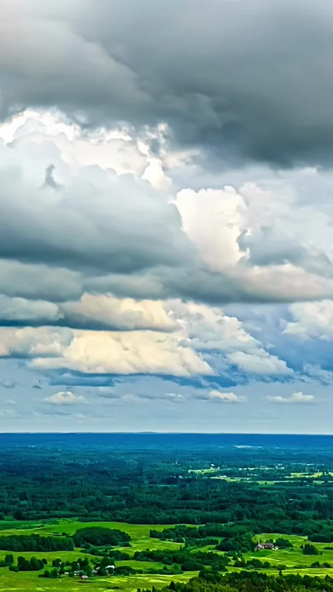 Aerial Timelapse of Towering Cumulus Clouds Over Green Latvian Countryside Stock Footage 345116565