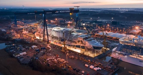 Aerial timelapse view of shipbuilding yard building a cruise ship Stock Footage 119984052