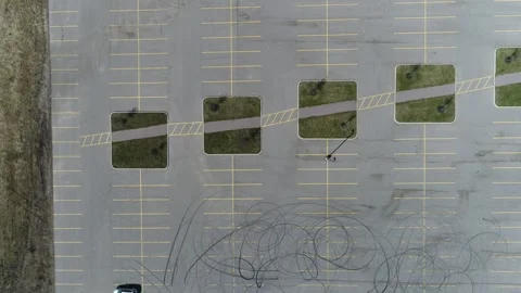 Car drift skid marks on empty parking lot, aerial drone top view