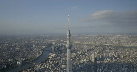 Aerial of Tokyo Skytree tower surrounded by city and river, Sumida, Tokyo Stock Footage 136099438