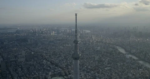 Aerial of Tokyo Skytree tower surrounded by city and river, Sumida, Tokyo Stock Footage 136099899