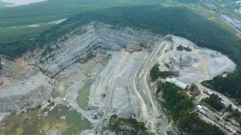 AERIAL. Top angle view of big career and excavators pours sand into the truck Video stock 113530542