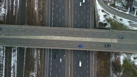 Aerial top down 4k video of the 401 Highway in Ajax Ontario while snowing Stock Footage 230096653