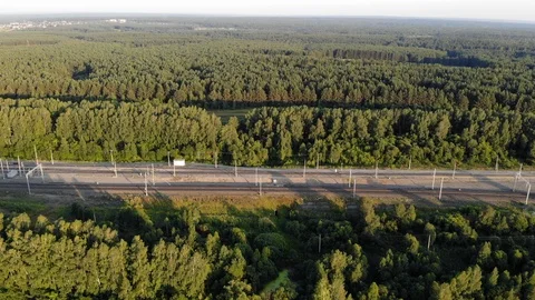 Aerial top down 4k view of the railway along the forest in summer at sunset Stock-Footage 123879960