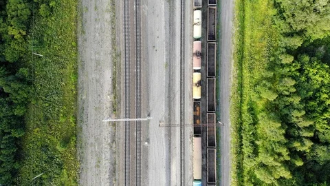 Aerial top down 4k view of railway tracks with an empty cargo wagons in summer Stock Footage 123933976