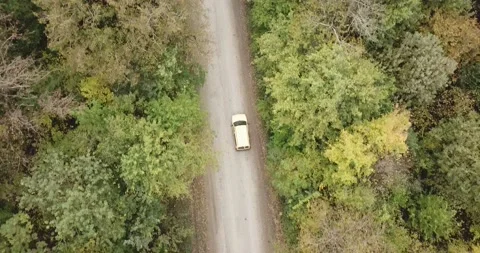 Aerial top down 4k view of white car driving on country road Stock Footage 141908338