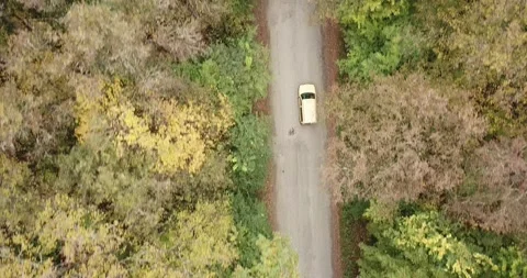 Aerial top down 4k view of white car driving on country road Stock Footage 141908372