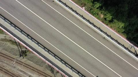 Aerial top down 4k view car driving. Cinematic drone shot flying over road. Top Vidéo 143904847
