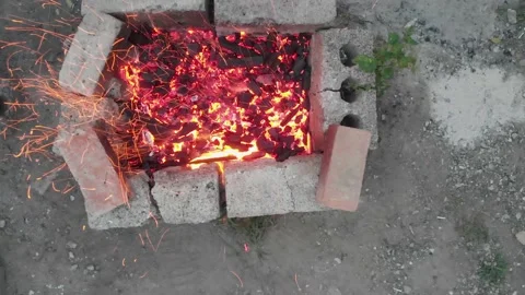Aerial top down 4k view of stirring wood burning charcoal in homemade barbecue Stock Footage 147358298