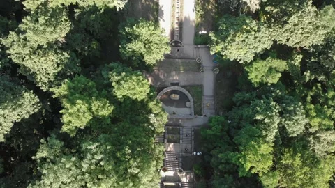 Aerial top down 4k view of green park with paths and people walking along them Stock Footage 150391118