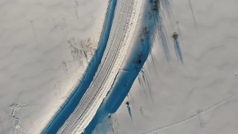 Aerial top down 4k view of winter tractor-cleared road. Road among snow. Stock Footage 170851383