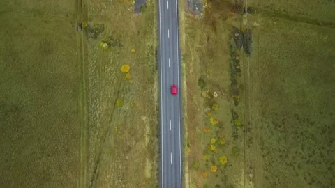 Aerial top down 4k view car driving on country road between lava in Iceland Stock Footage 261723266