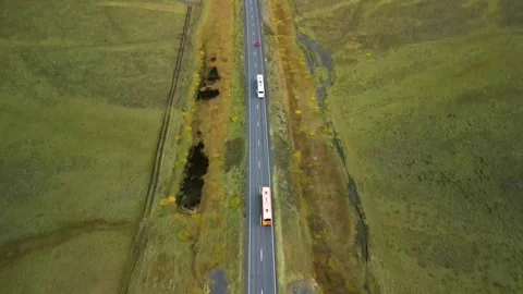 Aerial top down 4k view car driving on country road between lava in Iceland Stock Footage 261723386