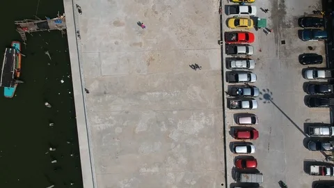 Aerial top down bird eye view car parking lot riverside near gulf of Thailand Stock Footage 83937031