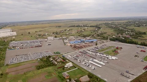 Aerial top down bird view of new car storage parking lot showing imported new Stock-Footage 80120767