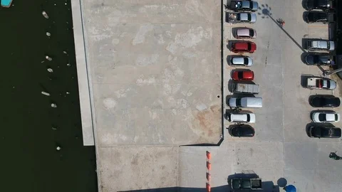 Aerial top down bird view car parking lot riverside near gulf of Thailand Stock Footage 83936894