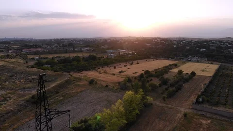 Aerial top down bird view on Farm, Field, surrounded by Mountain on sunset Stock Footage 112728583