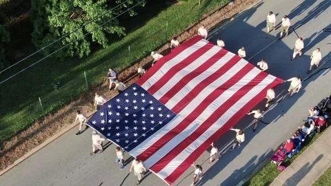 Aerial top down birds eye view of Boy Scouts of America carrying US star Stock Footage 117098078