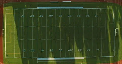 Aerial top down birds eye view of a football field at sunrise. Stock Footage 151779092