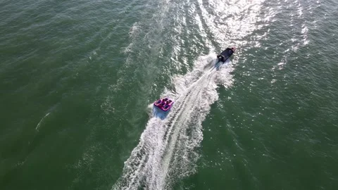 Aerial top down a boats pull the rubber float Stock Footage 169418703