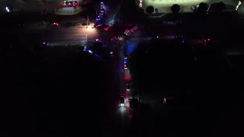 Aerial top down of car crash on junction of American suburbia at night Stock-Footage 319257332
