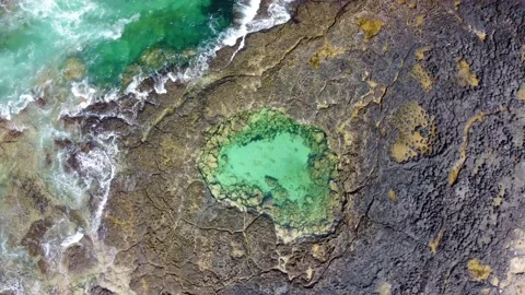 Aerial top down clip of a private secluded natural pool Fuerteventura Stock Footage 196984932