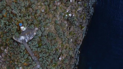 Aerial top down close up view of faraglione grande on the East coast of Sicily Stock Footage 109565381