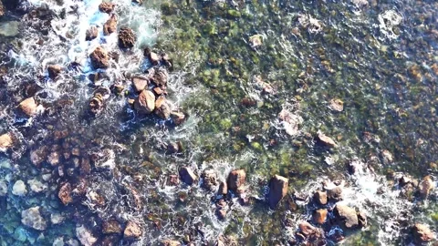 Aerial Top Down Close Up of Waves Crashing on Rocks Texture 4K Stock Footage 329058809