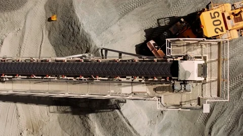 Aerial top down of coal conveyor belt piling up coal at a depot.  Stock Footage 158182859