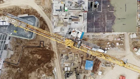 Aerial top down construction tower crane working on building site Stock Footage 152529597
