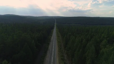 AERIAL, TOP DOWN: Dark colored car driving down an asphalt road crossing the Video stock 125466326