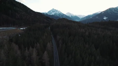 Aerial top down: Dark colored car driving down an asphalt road crossing the vast Video stock 273121041