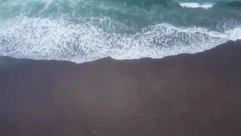 Aerial Top Down Dark Sand Beach Ocean Waves Surf Coastline Drone Overhead Stock Footage 335485086