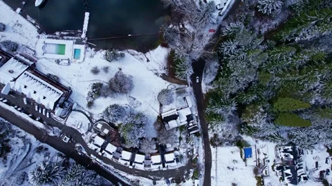 Aerial top down dolly in over snowy shore and turquoise Nahuel Huapi Lake in Stock Footage 334178207