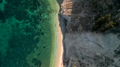 Aerial top down drone flight along Spiaggia di Sansone beach on Elba Island.. Stock Footage 318639974
