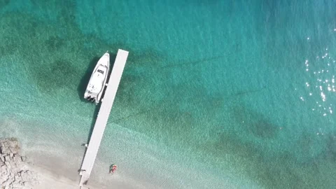 Aerial top-down drone landing over a beach pier Stock Footage 336601491