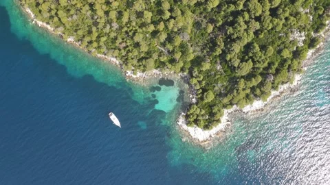 Aerial top-down drone rise over a yacht in Skopelos Stock Footage 336604312