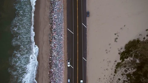 Aerial, top down, drone shot, of the Pacific coast highway 1, cars enter Stock Footage