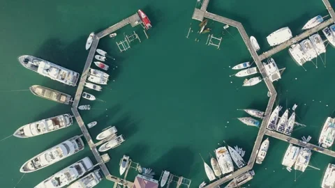 Aerial top down drone shot of Caribbean marina as boat drives in Stock Footage 137493975
