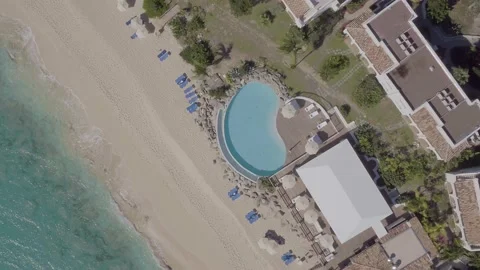 Aerial top down drone shot of Caribbean resort beachside pool Stock Footage 137499160