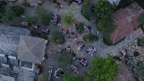 Aerial top down drone shot of people gathered at an outdoor venue Stock Footage 143356079
