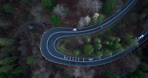 Aerial top down drone shot above the winding mountain road. Cars and trucks Stock Footage 201060775