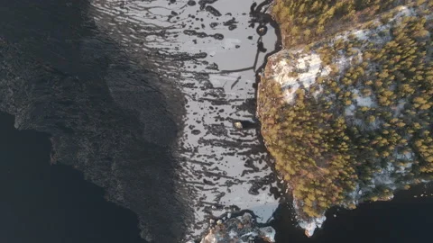 Aerial Top Down Drone Shot Of Frozen Lakeside During Sunset In Finland Stock Footage 224302203